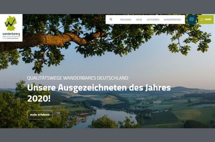 Die Startseite des neuen Internetauftritts Wanderbares Deutschland zeigt ein großflächiges Landschaftsbild und die Überschrift "Qualitätswege Wanderbares Deutschland: Unsere Ausgezeichneten des Jahres 2020". In der Ecke links oben erscheint das Logo, rechts oben die Menüleiste.